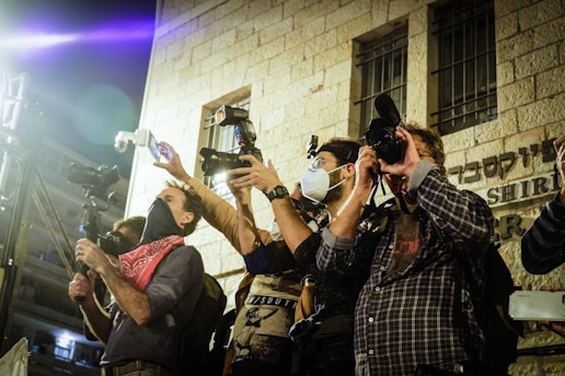 Journalists and photographers capturing moments at a vibrant cultural event hosted by WCC.