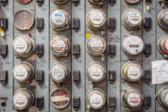 Technician inspecting an energy meter in a modern building