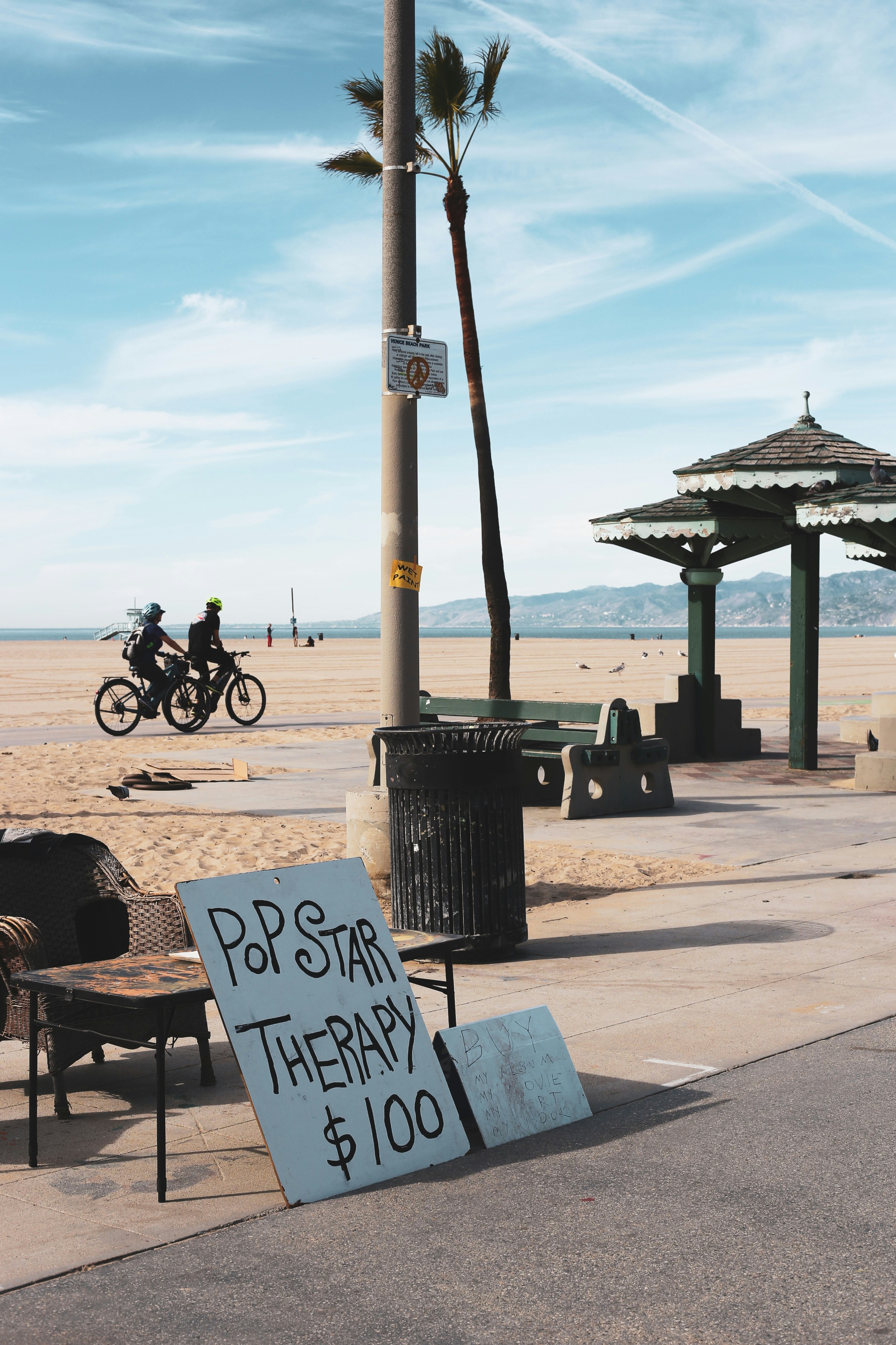 black steel lamp post near black steel bench during daytime