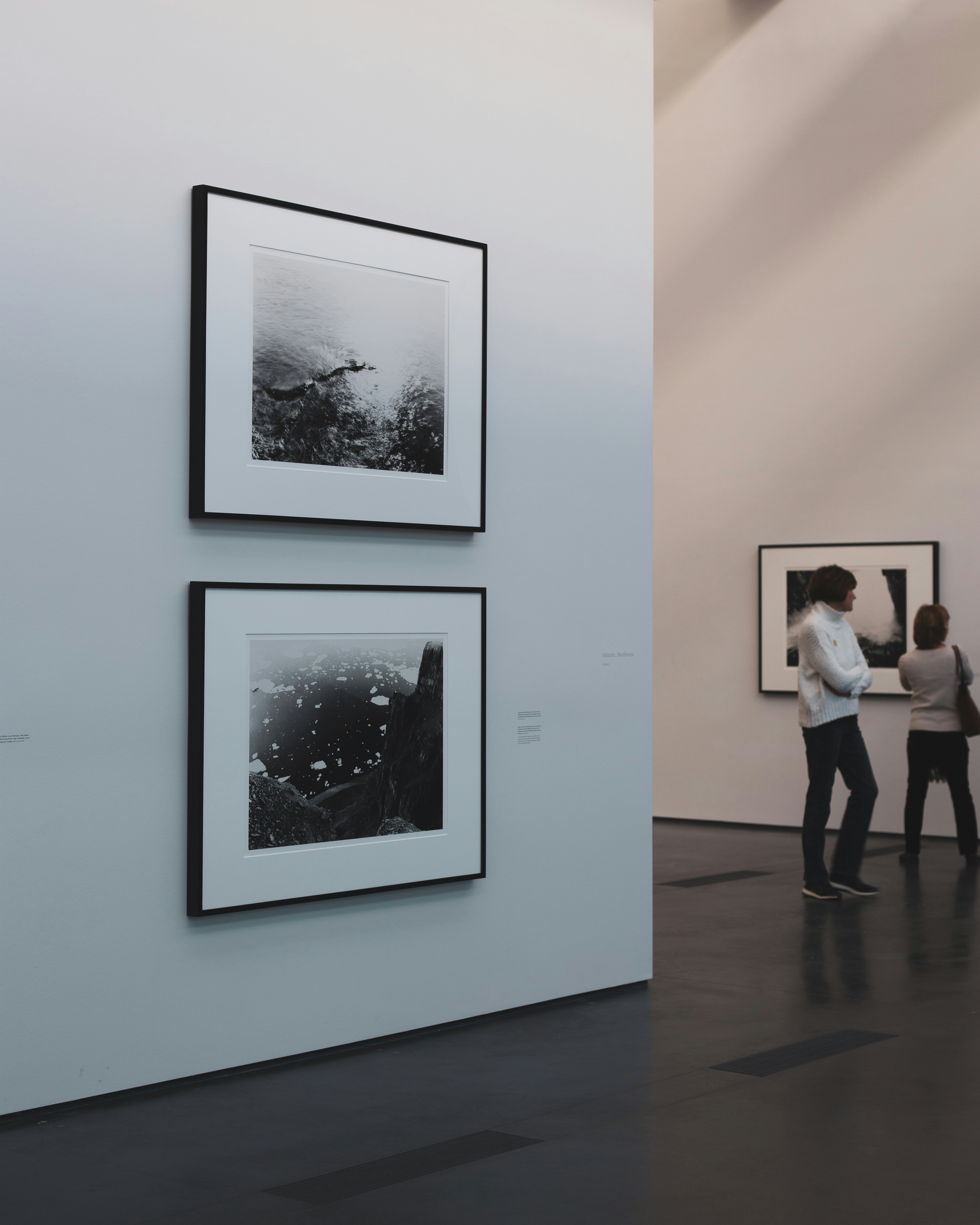 A serene corner of the gallery featuring minimalist black and white photography.