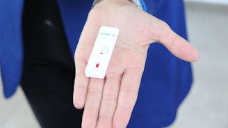 white rectangular device on persons hand