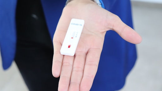 white rectangular device on persons hand