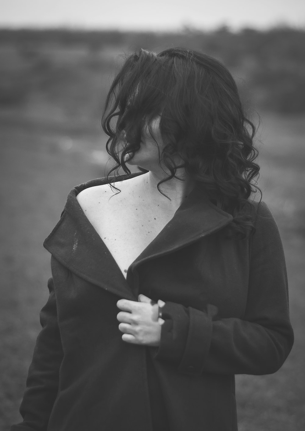 grayscale photo of girl in black coat