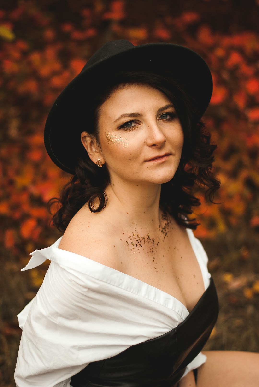 woman in white off shoulder top and black hat