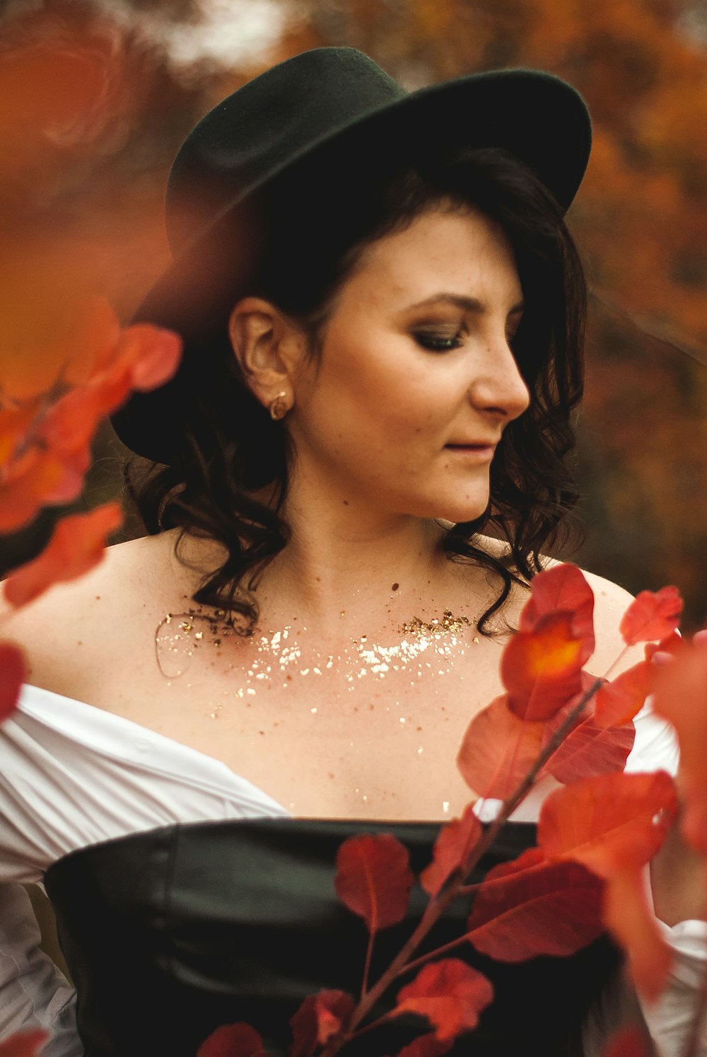 woman in white dress with red flower on her ear