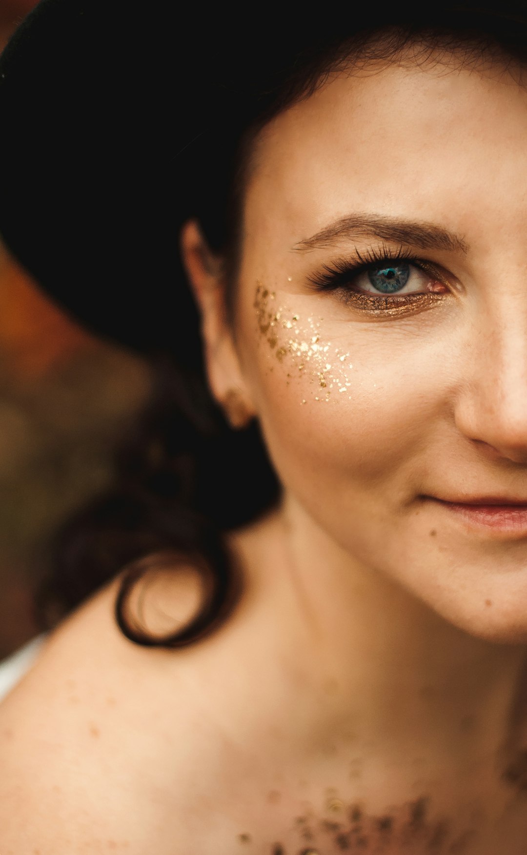 woman with blue eyes wearing black hat