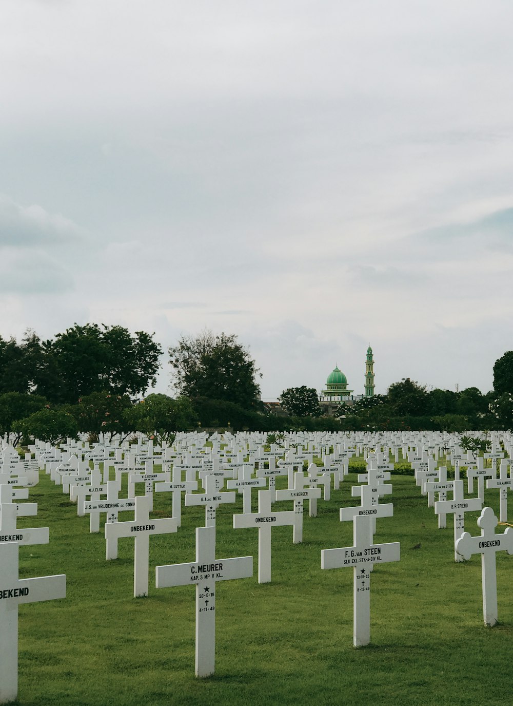 white cross on green grass field during daytime