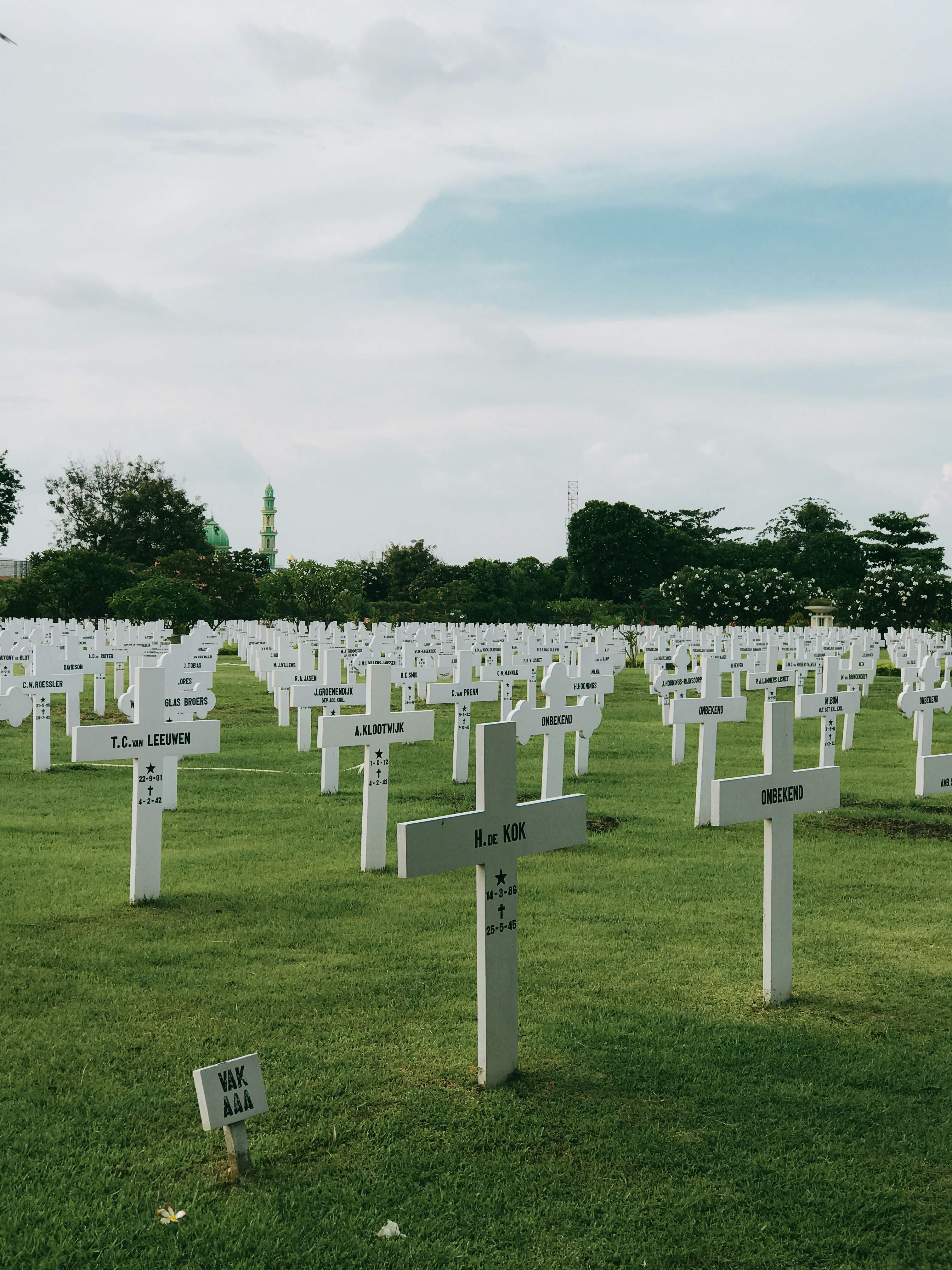 white cross on green grass field during daytime