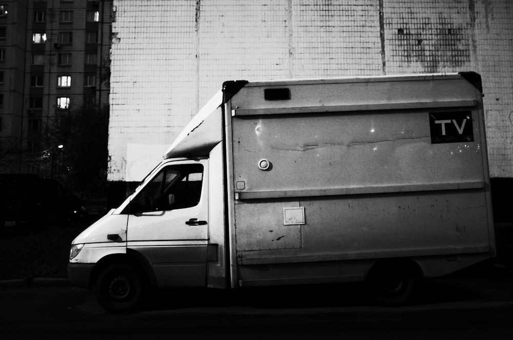 white van parked beside white wall