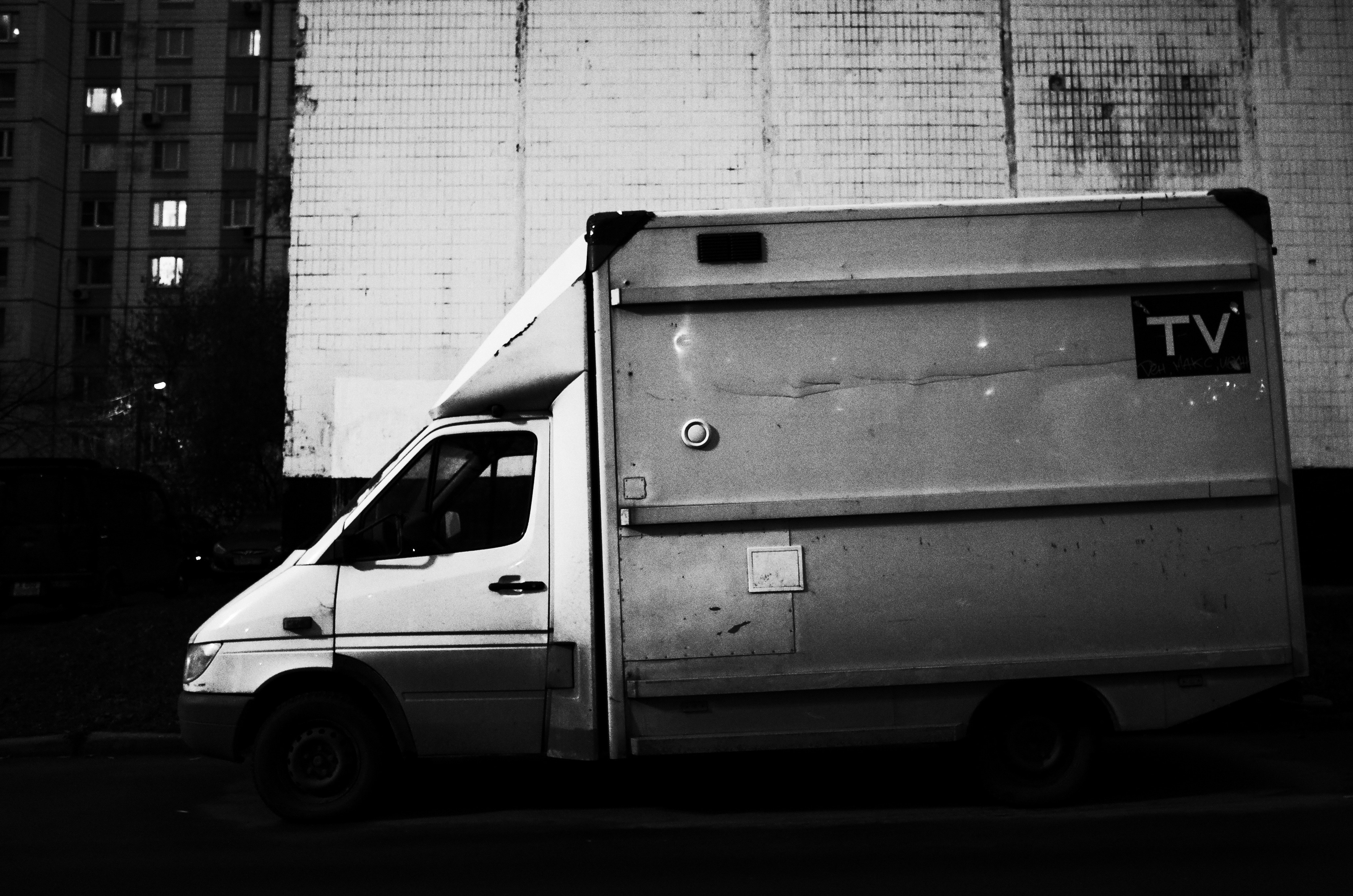 White van and transformer booth behind