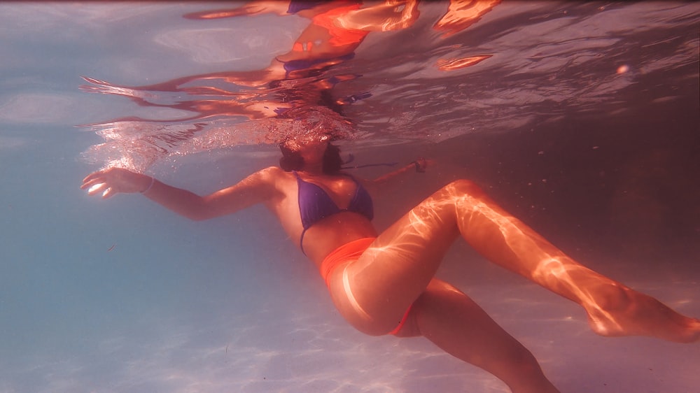 woman in black bikini lying on water