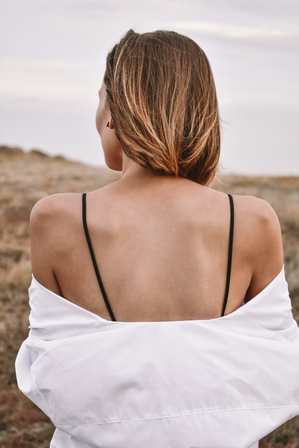 woman in white spaghetti strap top