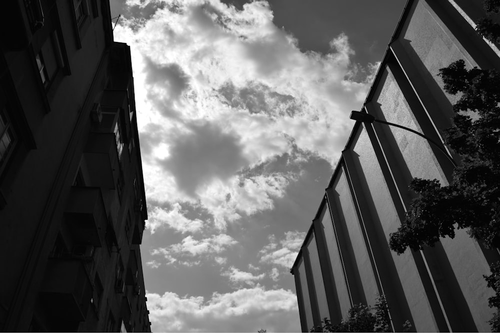 grayscale photo of concrete building under cloudy sky