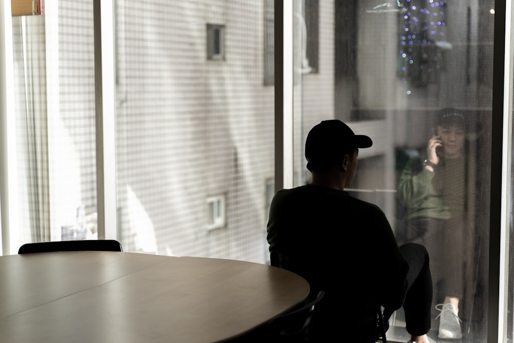 man in black shirt sitting on chair