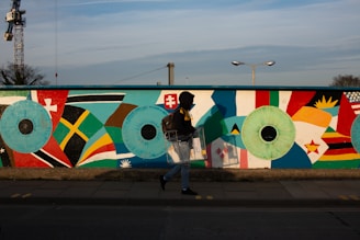 woman in black jacket and blue denim jeans holding white blue and red flag