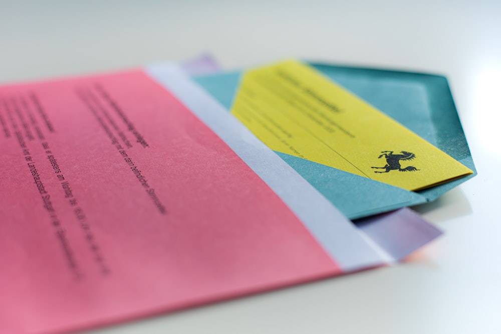 pink blue and yellow papers