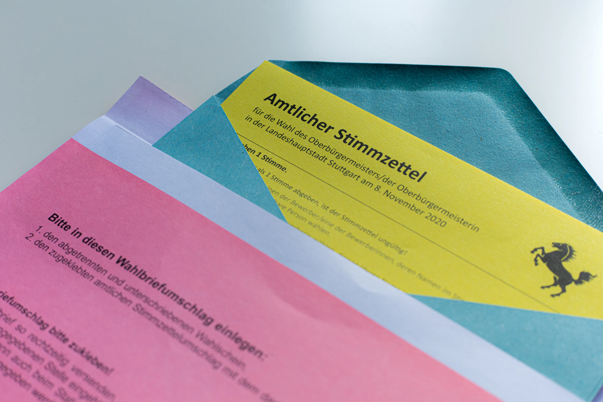 pink and yellow paper on blue textile