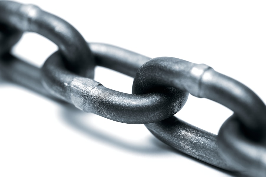 A grey metal chain on a white background, representing an unbroken lineage from an AI output back to its source records
