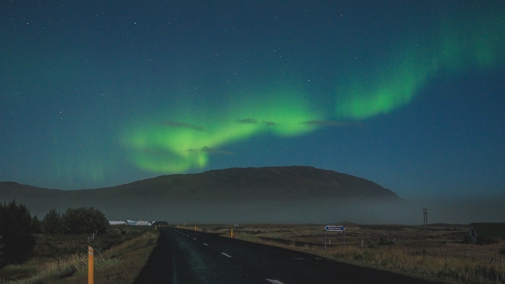 green aurora lights over the road