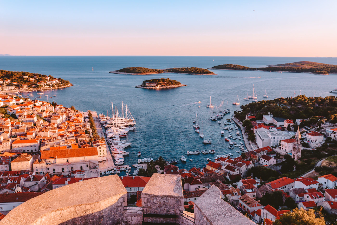 Sunset over Hvar town, its harbor, and the Pakleni Islands
