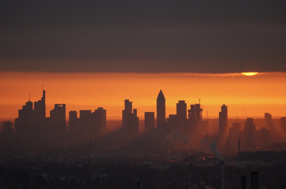 silhouette of city buildings during sunset