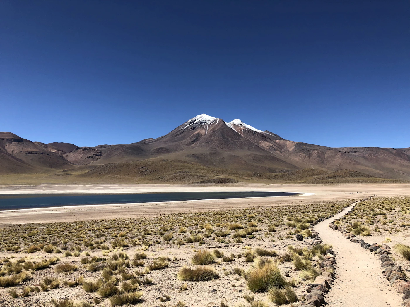 Atacama Desert volcanic landscape with rust-red hills and deep blue sky at high altitude