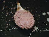 pink salt on black frying pan