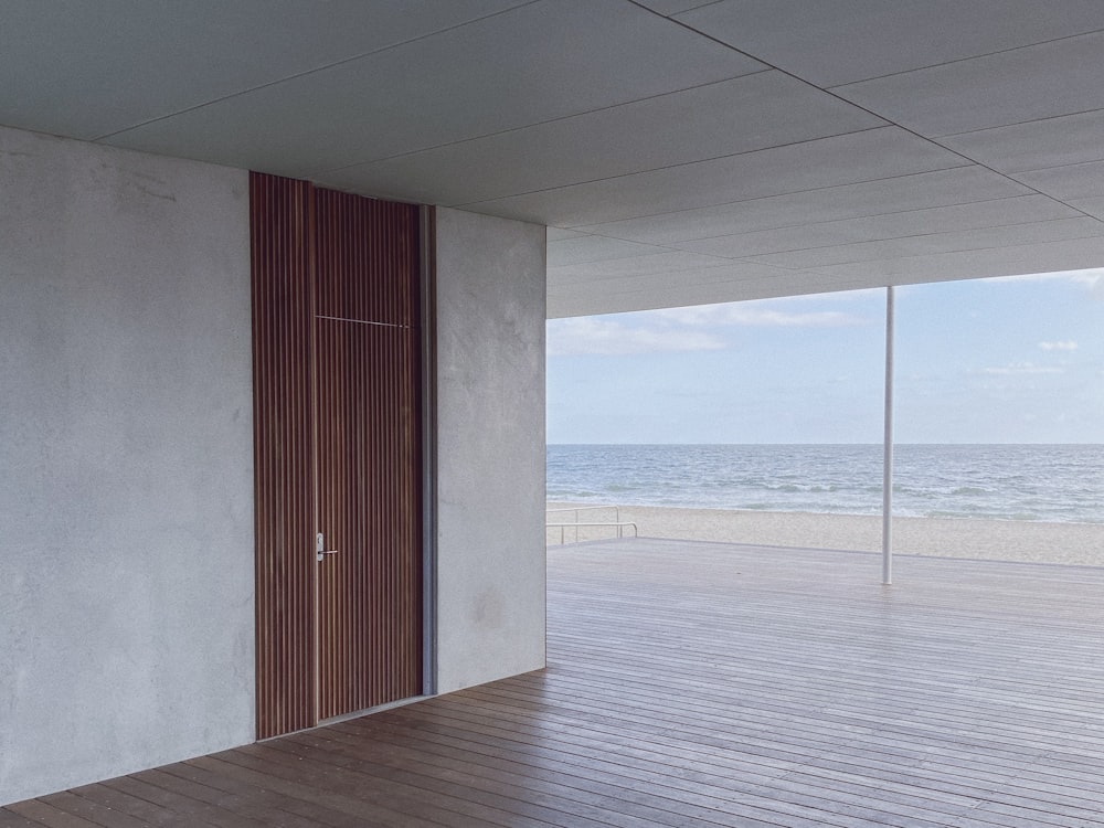 brown wooden door near body of water during daytime