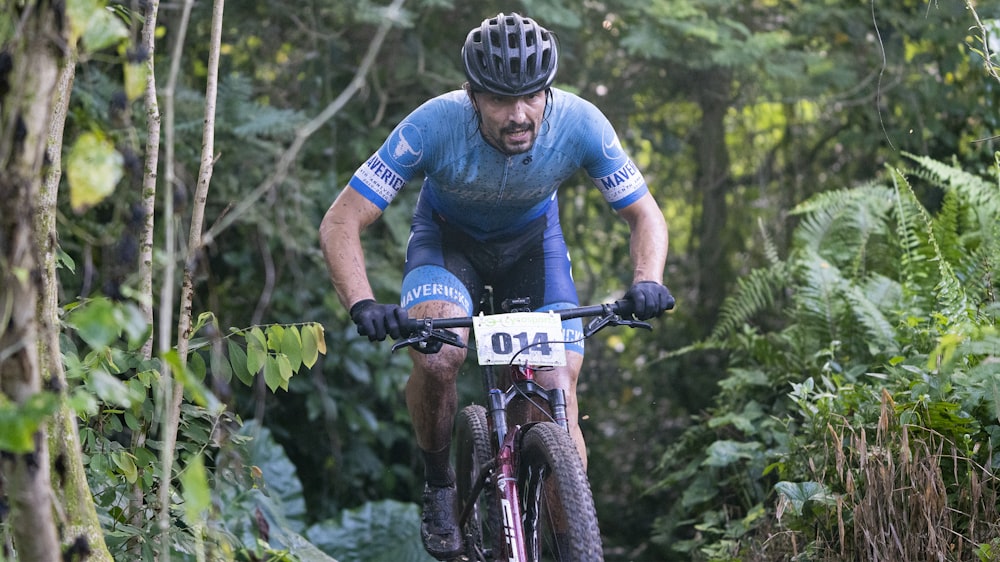 man in blue and red long sleeve shirt riding black mountain bike