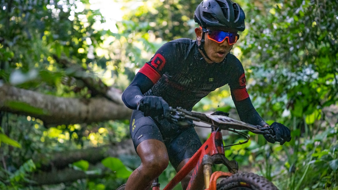 man in black and red long sleeve shirt riding on red and black mountain bike