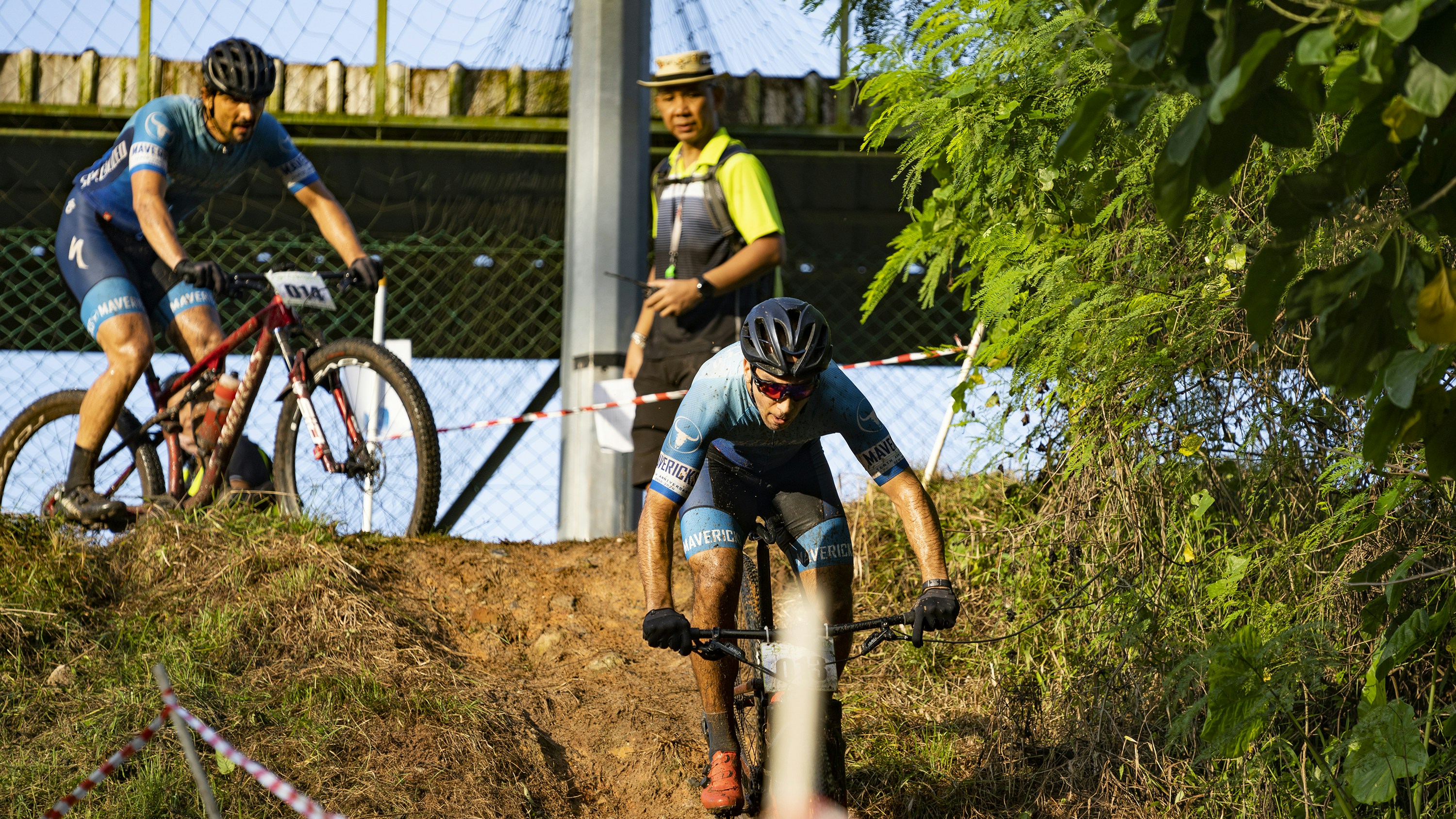 man in black and white helmet riding on bicycle during daytime