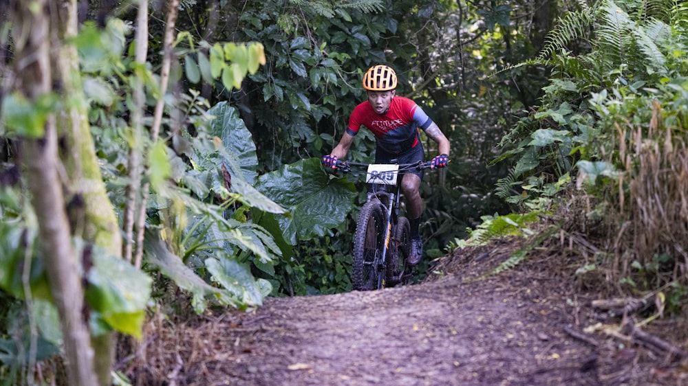 man in green and black long sleeve shirt riding on black mountain bike