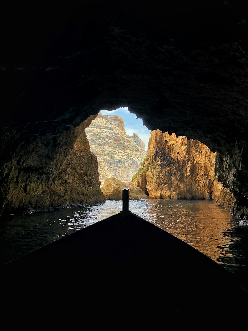 person standing on dock in cave