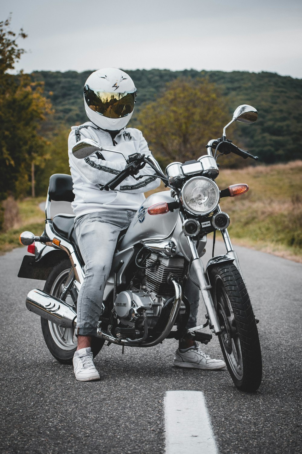 man in black helmet riding on black motorcycle during daytime