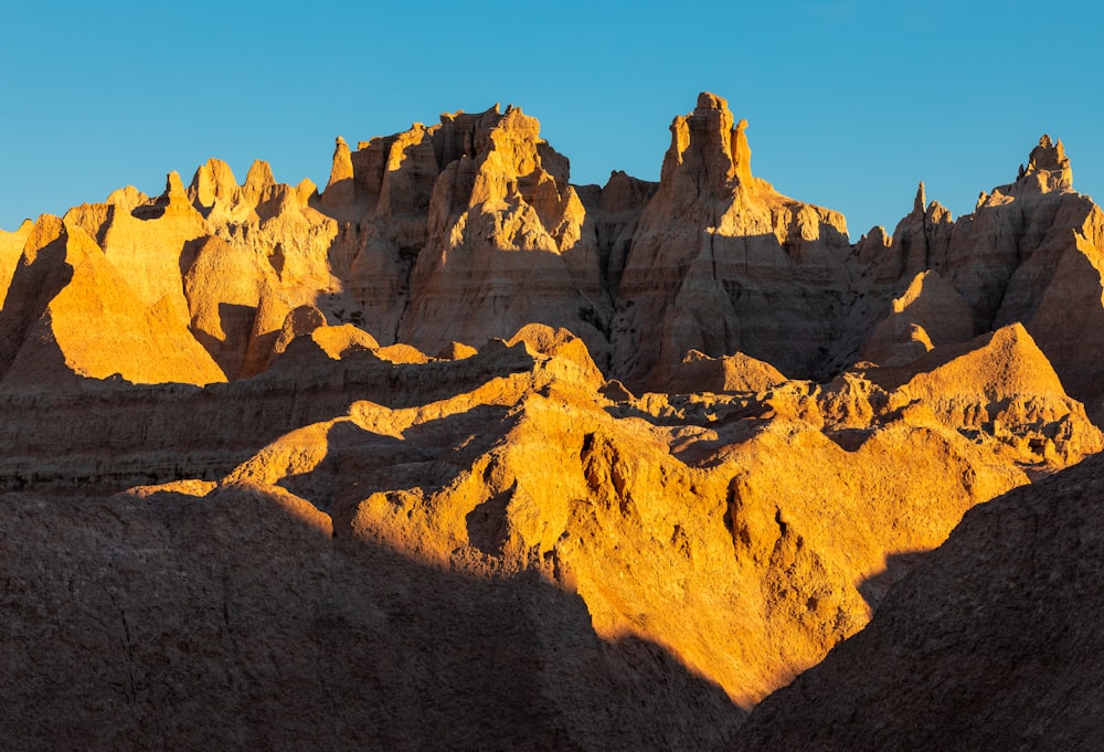 brown rocky mountain under blue sky during daytime