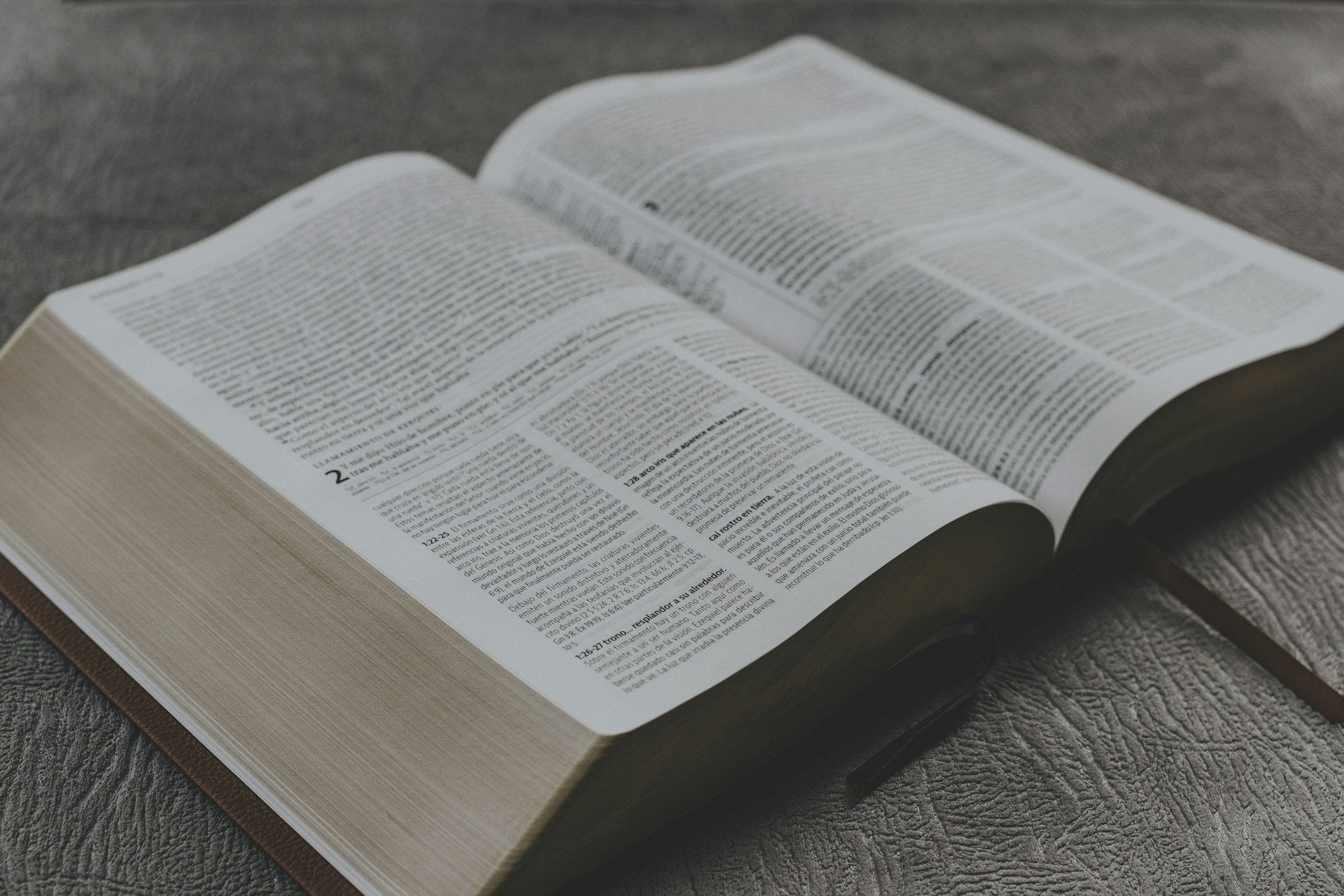 opened book on brown wooden table