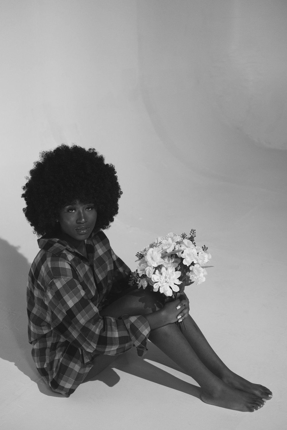 grayscale photo of woman holding bouquet of flowers