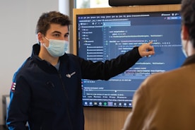 man in black jacket wearing white face mask