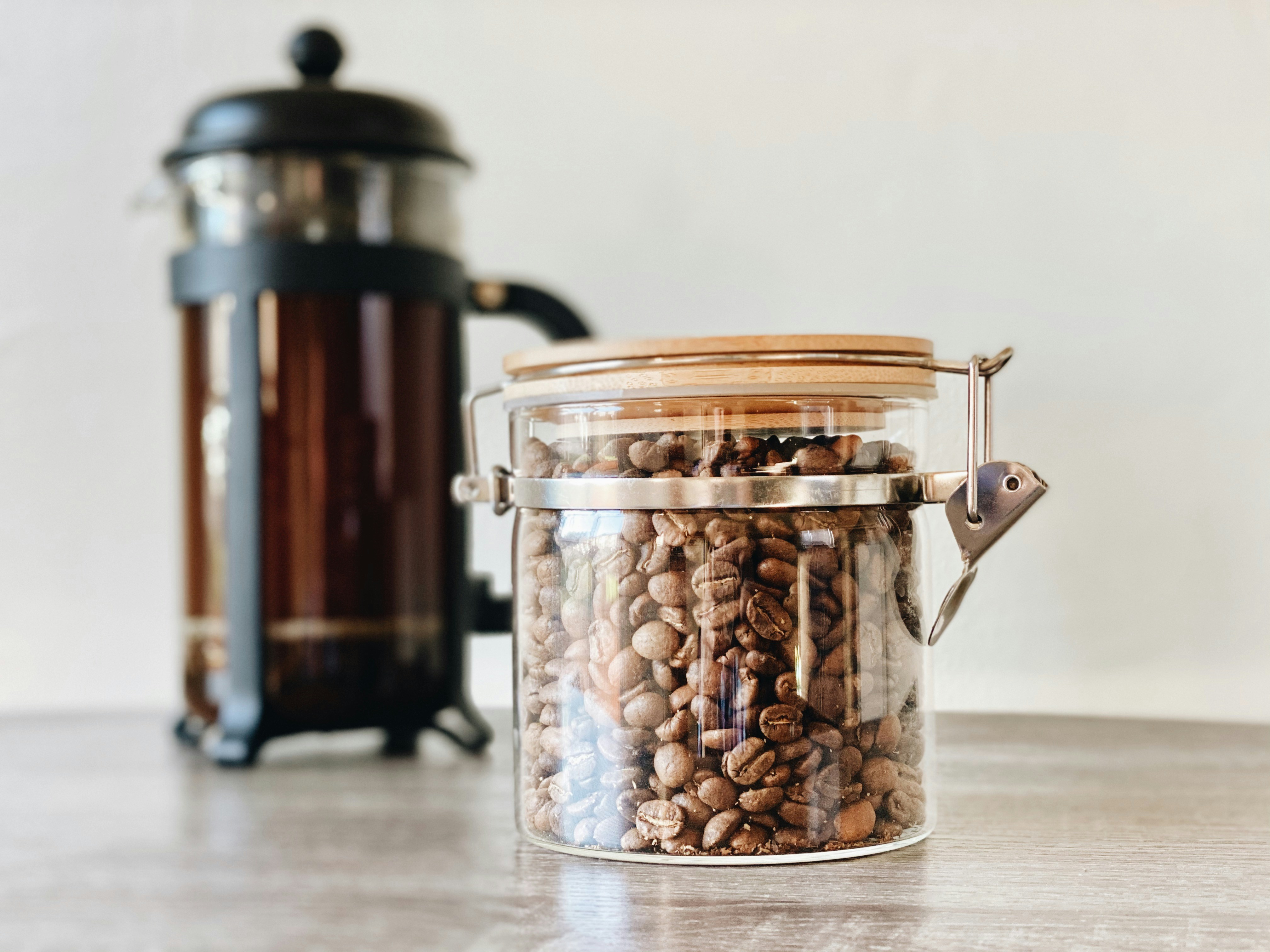 specialty coffee beans next to a French press
