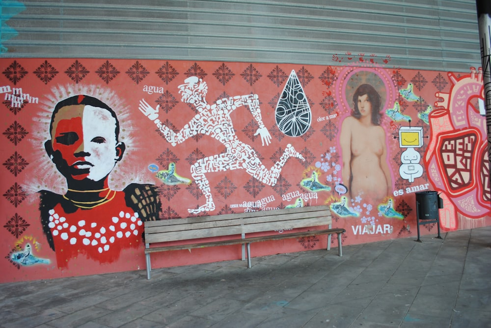 woman in red sleeveless dress standing beside wall with graffiti