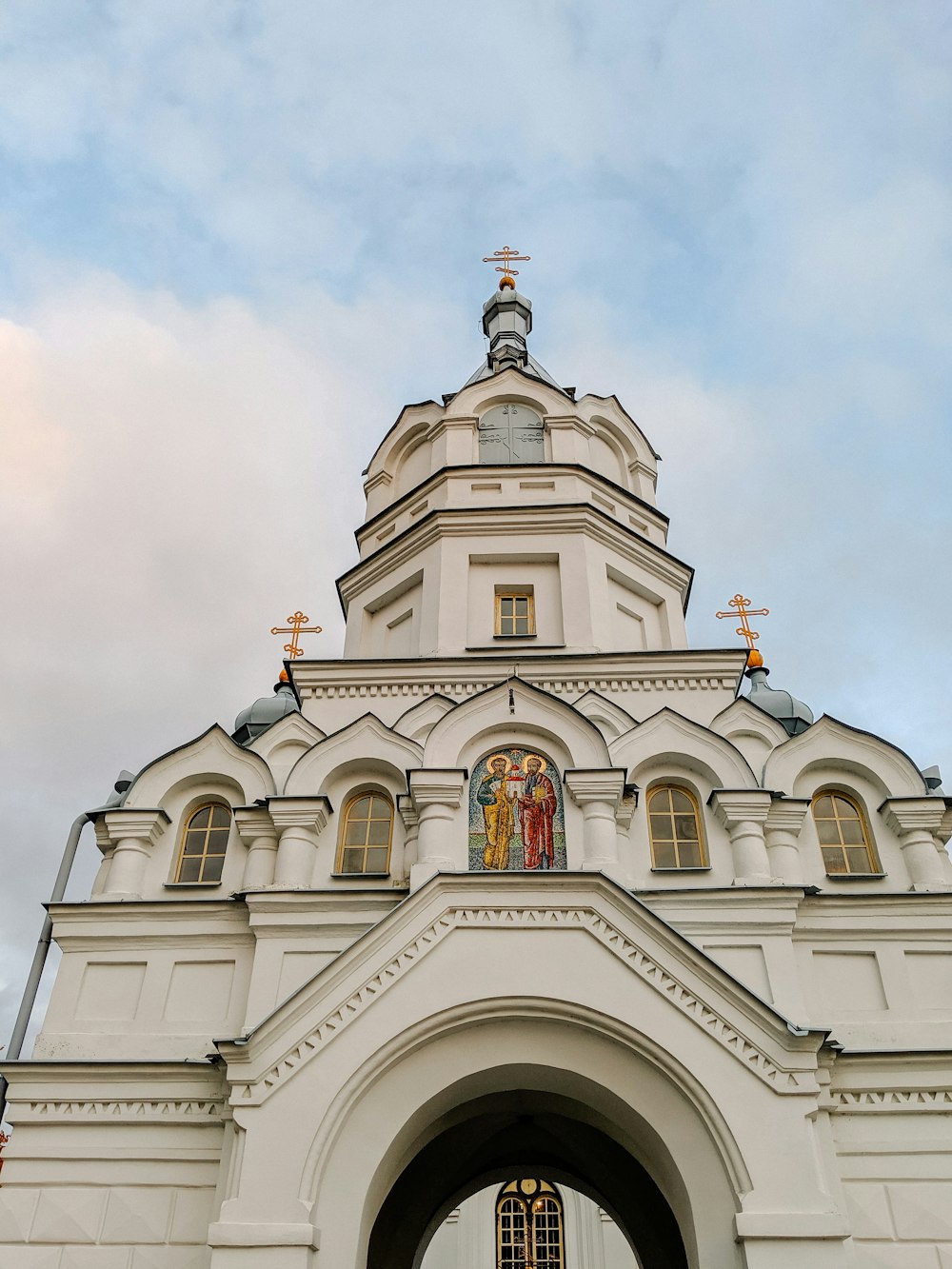 white and gray concrete church under white clouds during daytime