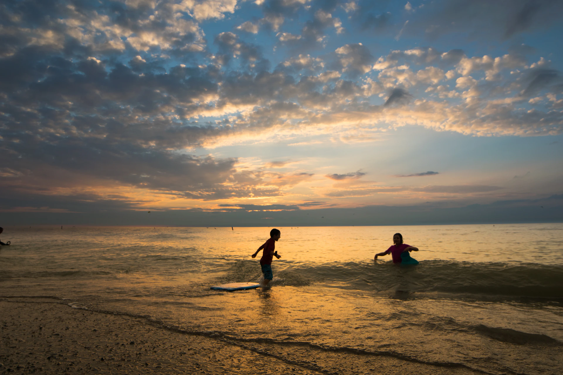 2 person on beach during sunset