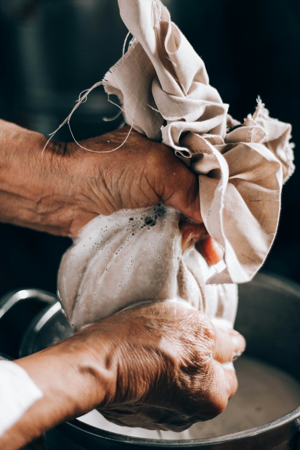 person holding white textile on left hand