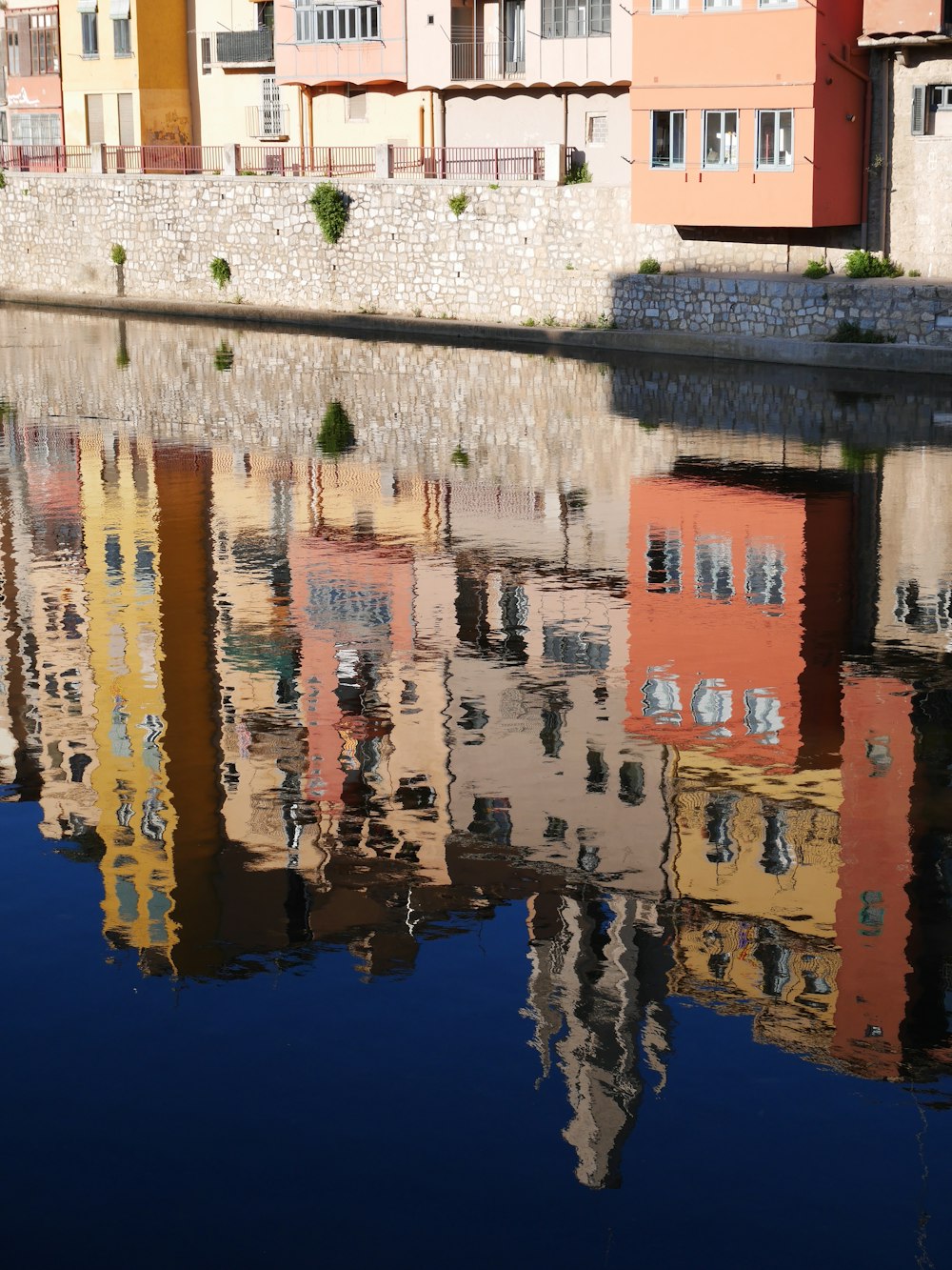 white and brown concrete building beside body of water during daytime