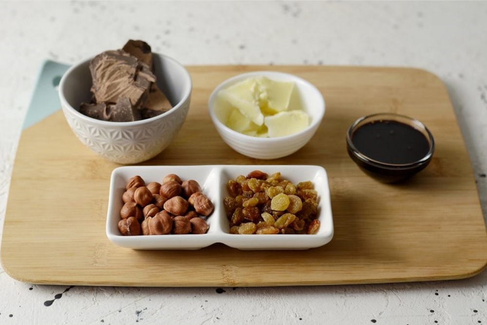 brown and white nuts in white ceramic bowls