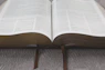 opened book on gray textile