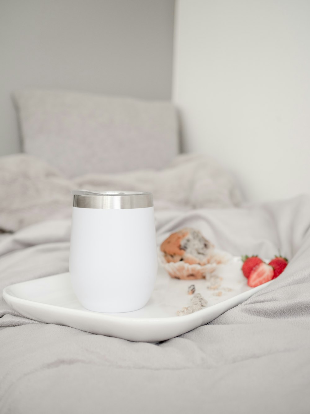 white ceramic mug on white ceramic plate