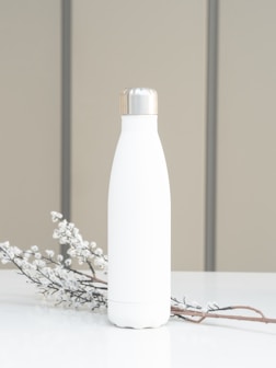 white bottle on white table