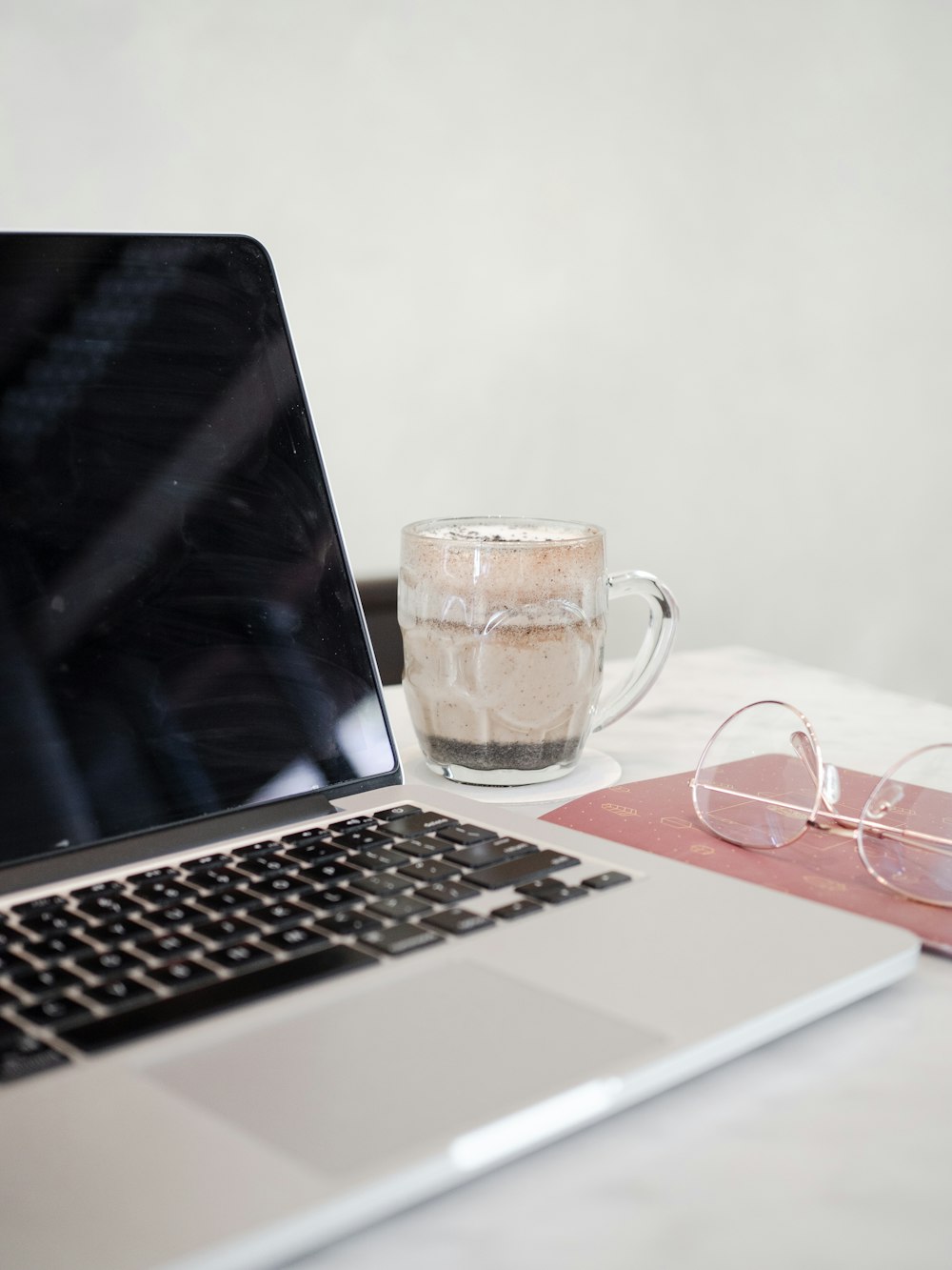 clear glass mug on macbook pro