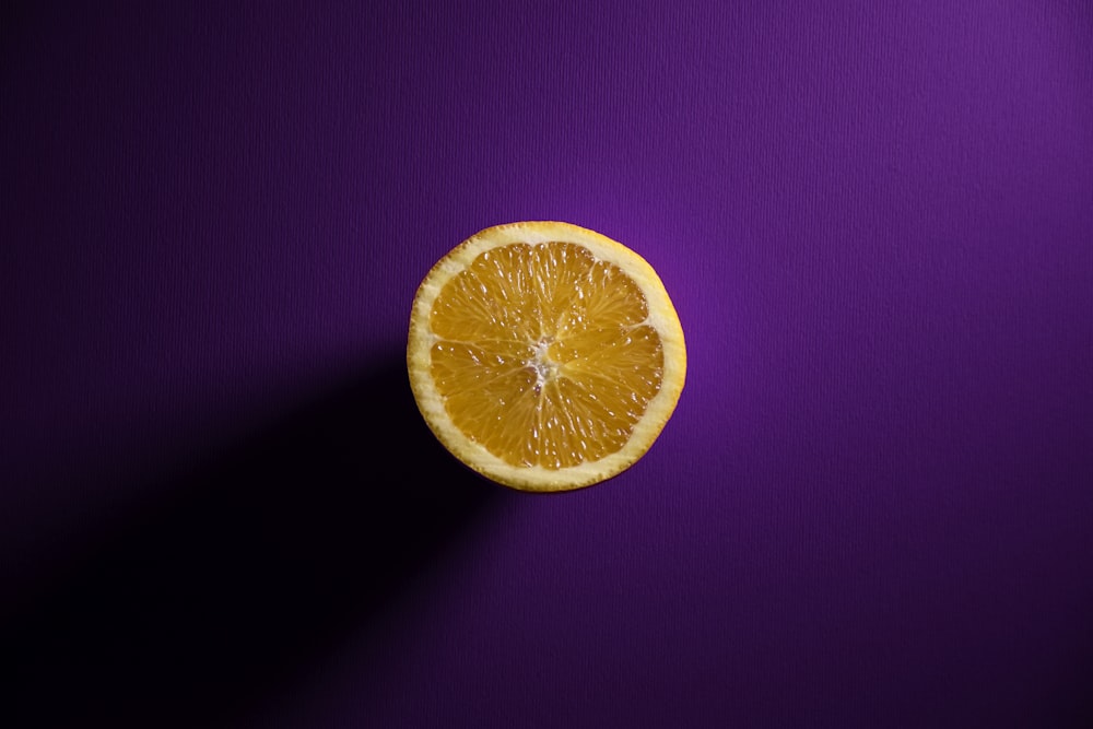 orange fruit on purple textile